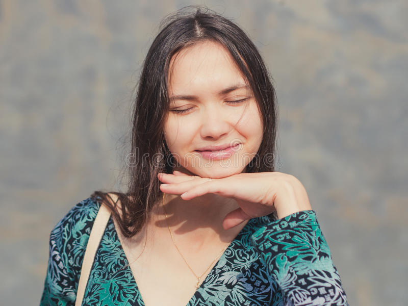 girl-eyes-closed-hands-under-his-chin-close-up-portrait-pretty-hand-sunny-outdoors-portrait-76500595